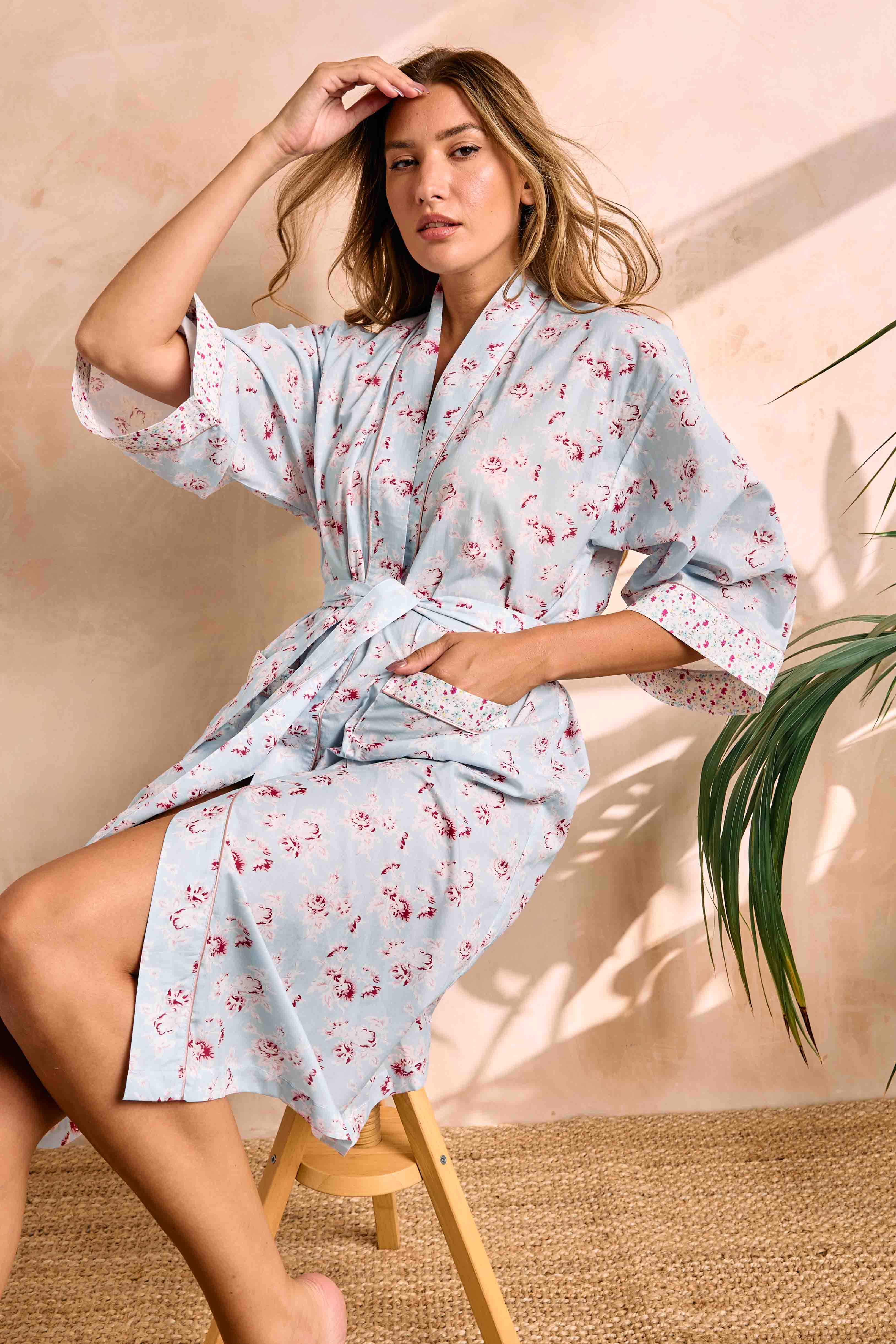 Light blue SuperVoile kimono with pink rose print, 3/4 sleeves, white floral cuffs, pink piping, tie belt, and pocket.
