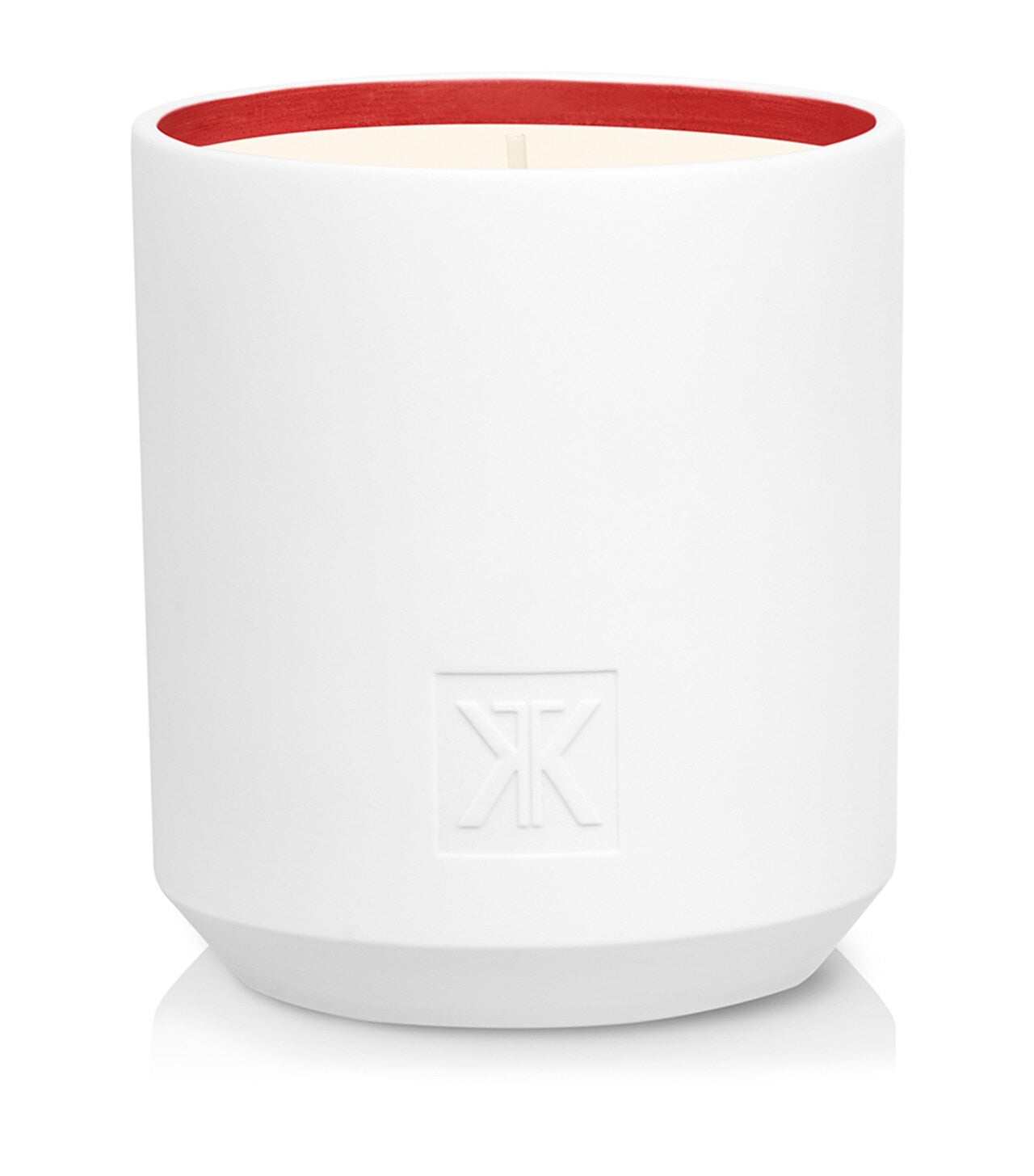 White cylindrical candle with a matte finish, red inner rim, cream wax, and an embossed 'MK' monogram on the front.