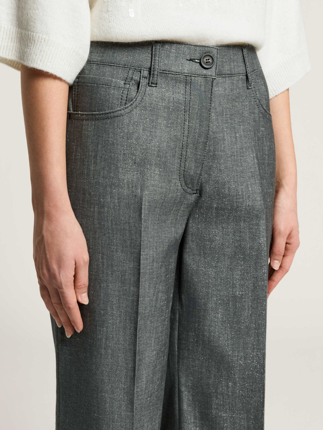 Mercury grey shimmering trousers with button closure, belt loops, and front slash pockets including a coin pocket.