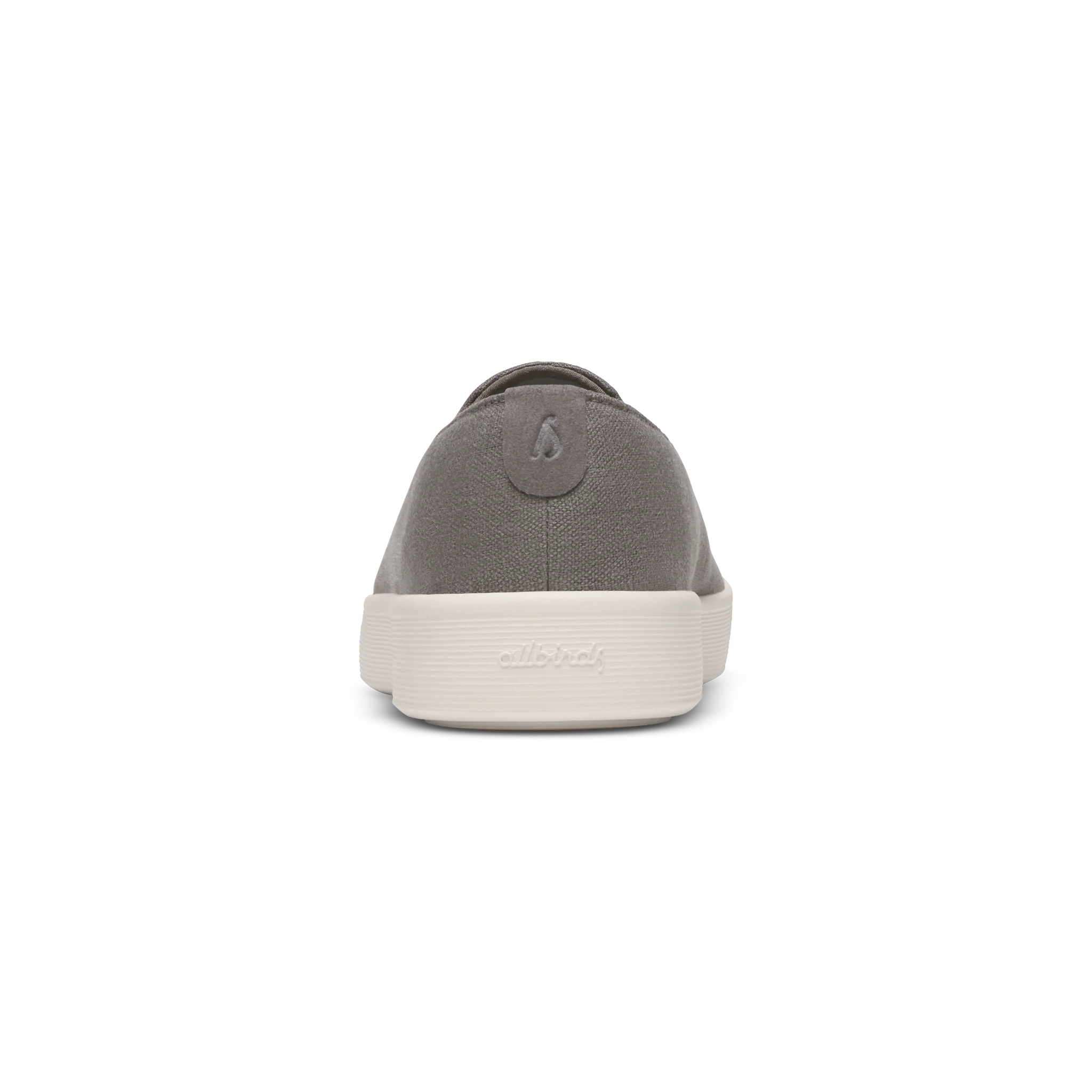 Grey fabric slip-on shoe with a thick, ridged off-white sole. A grey logo tab is on the heel, and 'allbirds' is embossed on t