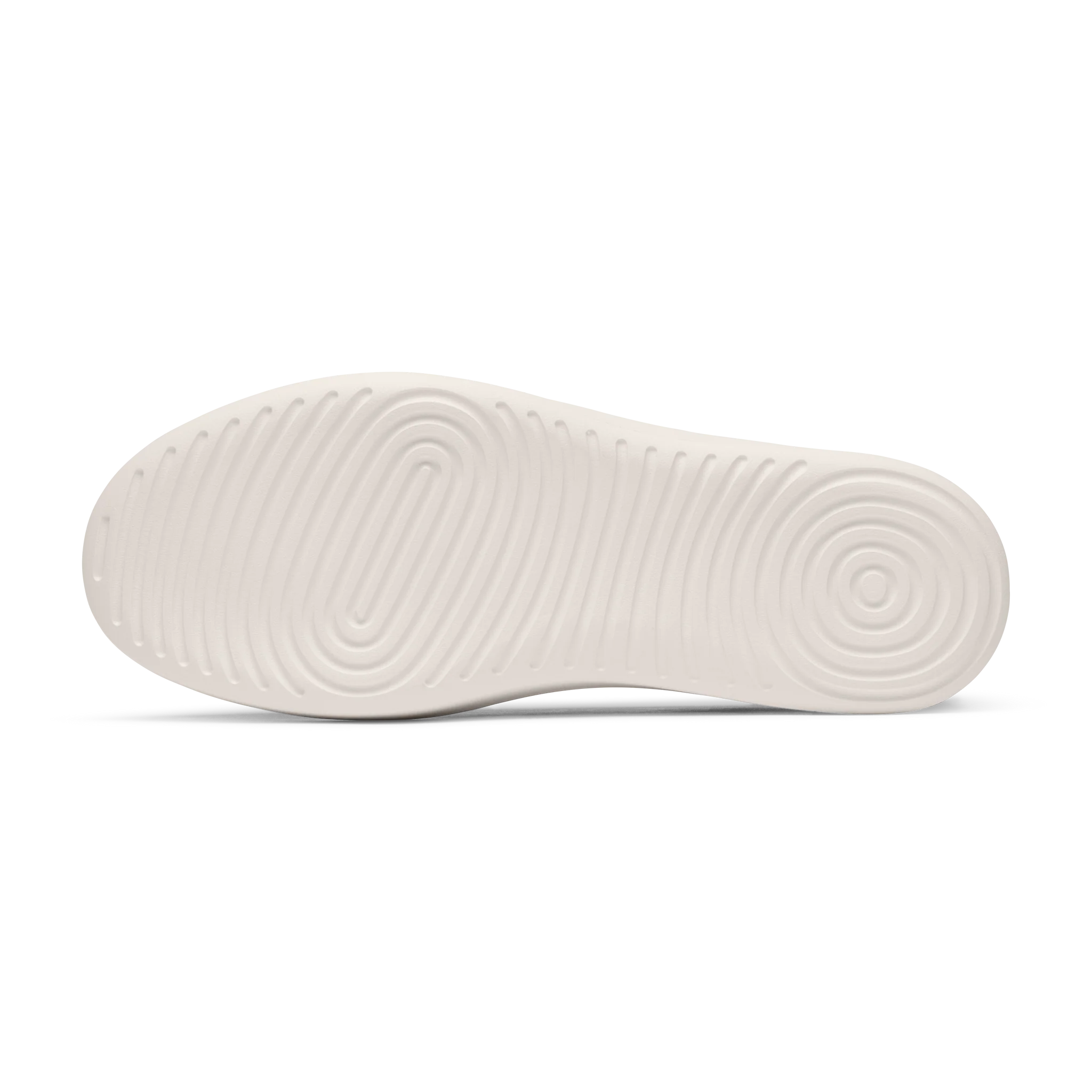 Cream-colored shoe sole with textured concentric oval patterns at the front and circular patterns at the back.