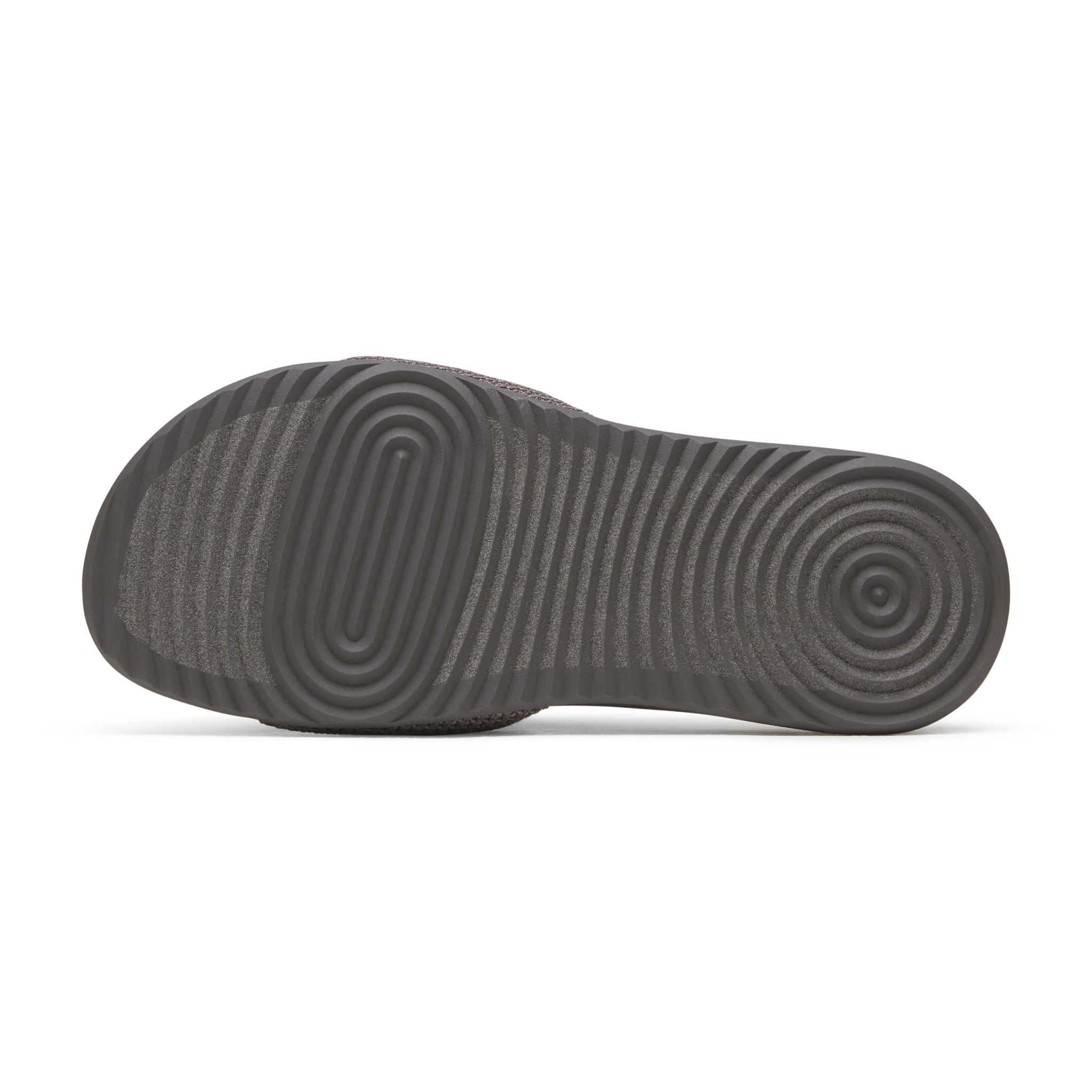 Grey slide sandal with a textured dark grey sole featuring concentric oval and circular ridges, and wavy horizontal lines.