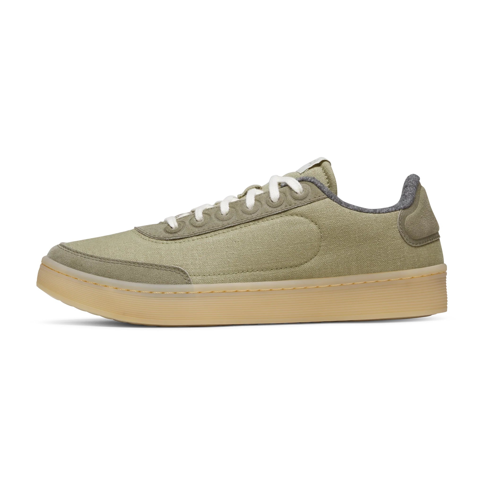 Greenish-beige low-top trainers with light grey suede-like overlays, white laces, and a light brown rubber sole.