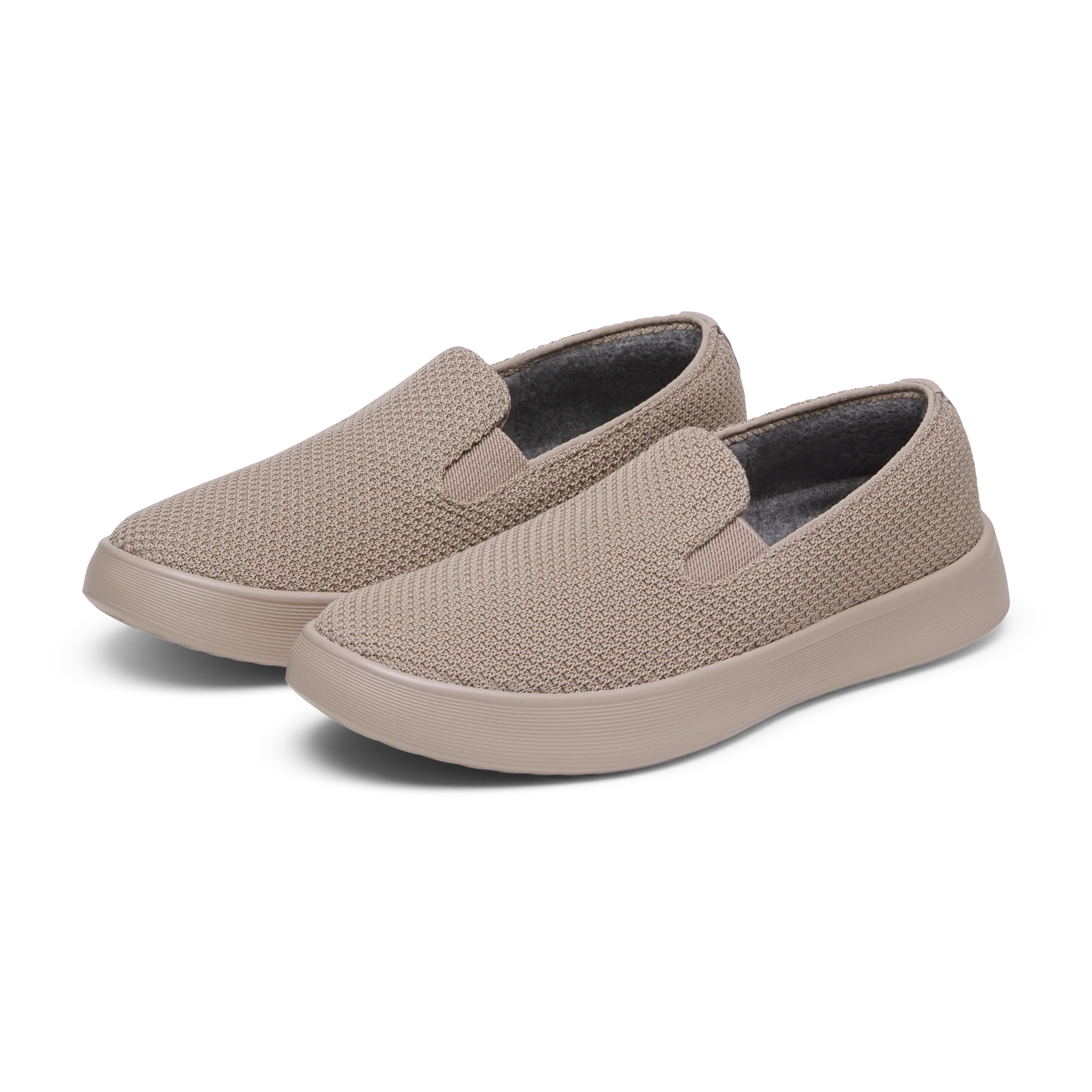 Pair of brown slip-on shoes with a textured knitted mesh upper, matching solid soles, and a visible grey interior lining.