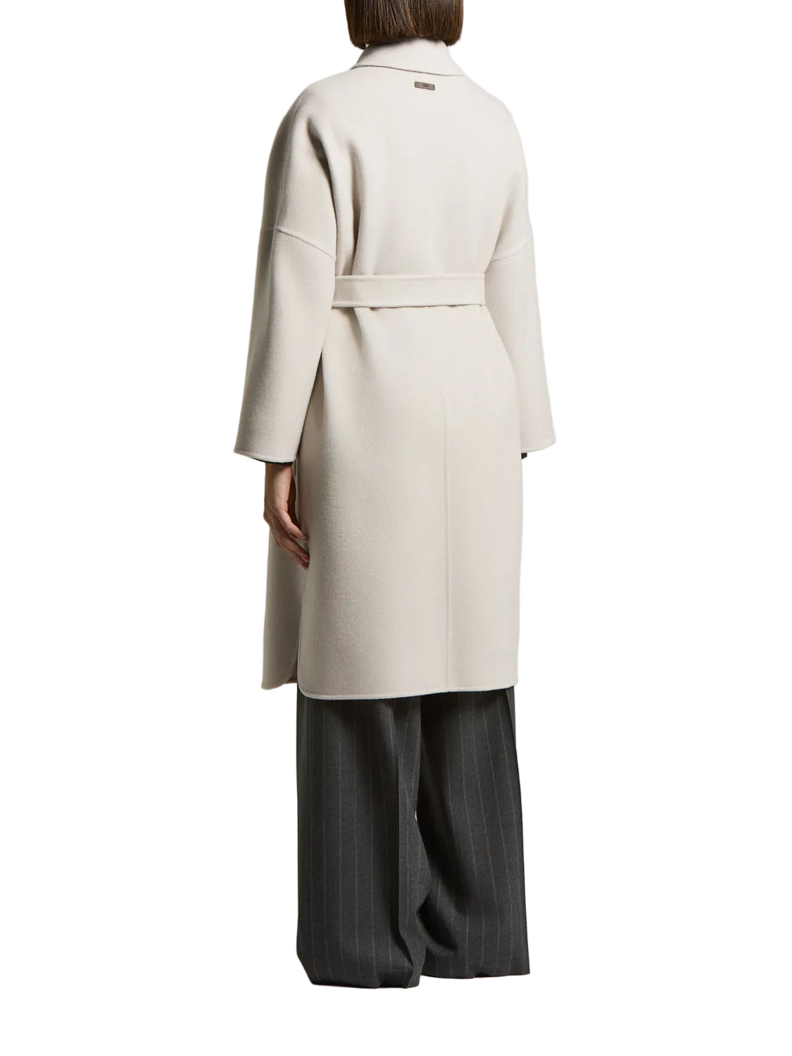 Icy beige long coat with a wide collar, drop shoulders, and a matching fabric belt tied at the back. Gold-toned tag on collar