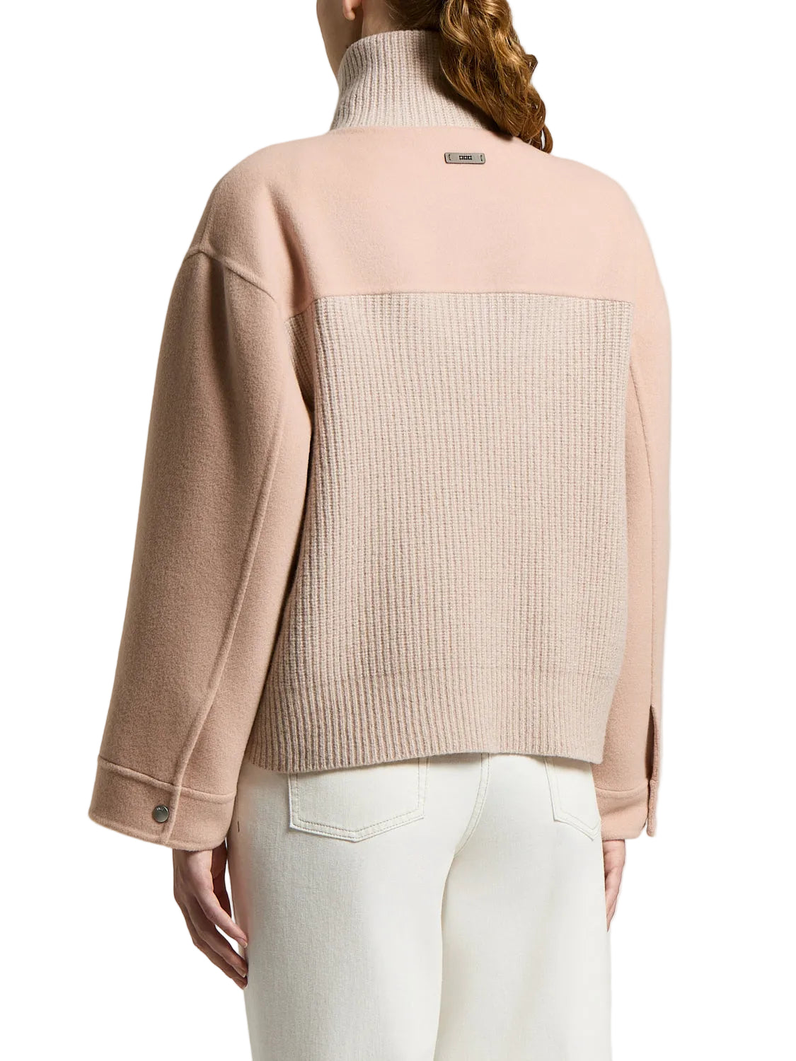 Two-tone beige coat: smooth upper back/sleeves, ribbed knit lower back. Ribbed turtleneck, buttoned cuffs, and a small back t