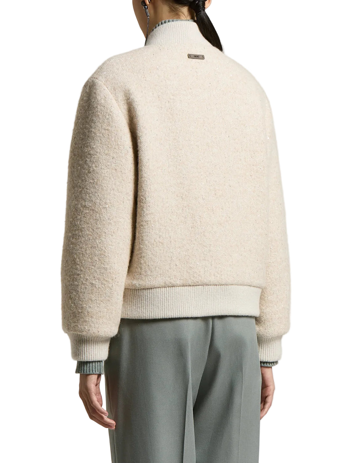 Beige bomber jacket with textured, sequined fabric. Ribbed collar, cuffs, and hem. Small dark-toned tag on the back collar.