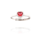 Silver-toned adjustable ring with a red heart-shaped faceted stone surrounded by a halo of clear smaller stones.