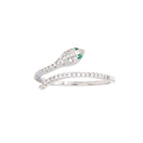 Silver-toned snake ring with pave-set clear stones and two small green stones for eyes, on a white background.