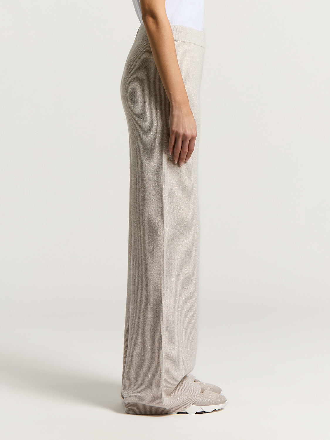 Icy beige wide-leg knit pants with a subtle shimmer, ribbed texture, and vertical side seams.