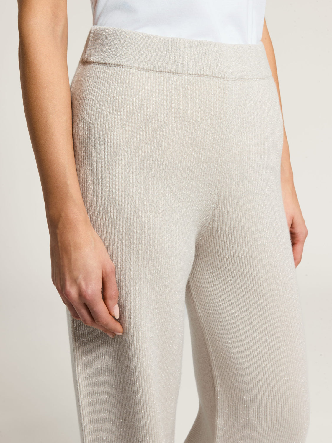 Icy beige ribbed knit pants with a wide waistband and subtle shimmer.