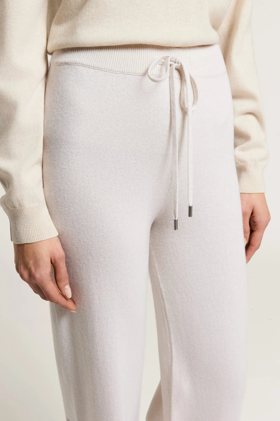 Star dust beige knit pants with a ribbed waistband and a drawstring with silver-toned tips.