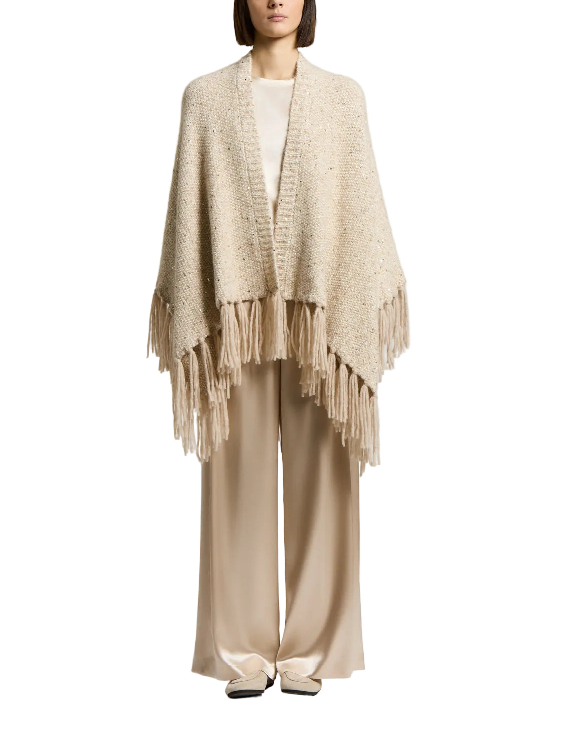 Star dust beige alpaca and wool cape with an open front, chunky knit texture, subtle sequins, and a fringed hem.