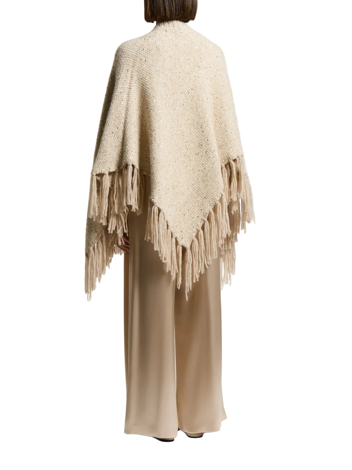 Beige alpaca and wool cape with a chunky knit texture, covered in small gold-toned sequins, and featuring a thick fringed hem