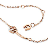 Rose-gold-toned stainless steel necklace with a crystal-studded Aigner "A" key pendant, "AIGNER" engraved, and an "A" charm.