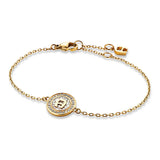 Gold-toned Aigner bracelet with a central circular charm featuring a white iridescent inlay, gold 'A' logo, and clear pavé st