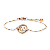 Rose gold-toned stainless steel chain bracelet with a central twisted wire ring and a stone-embellished 'A' logo.