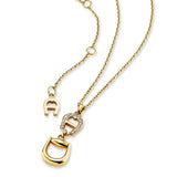 Gold-toned short necklace with a polished stirrup-shaped pendant, an Aigner 'A' logo, and clear pavé-set stones.