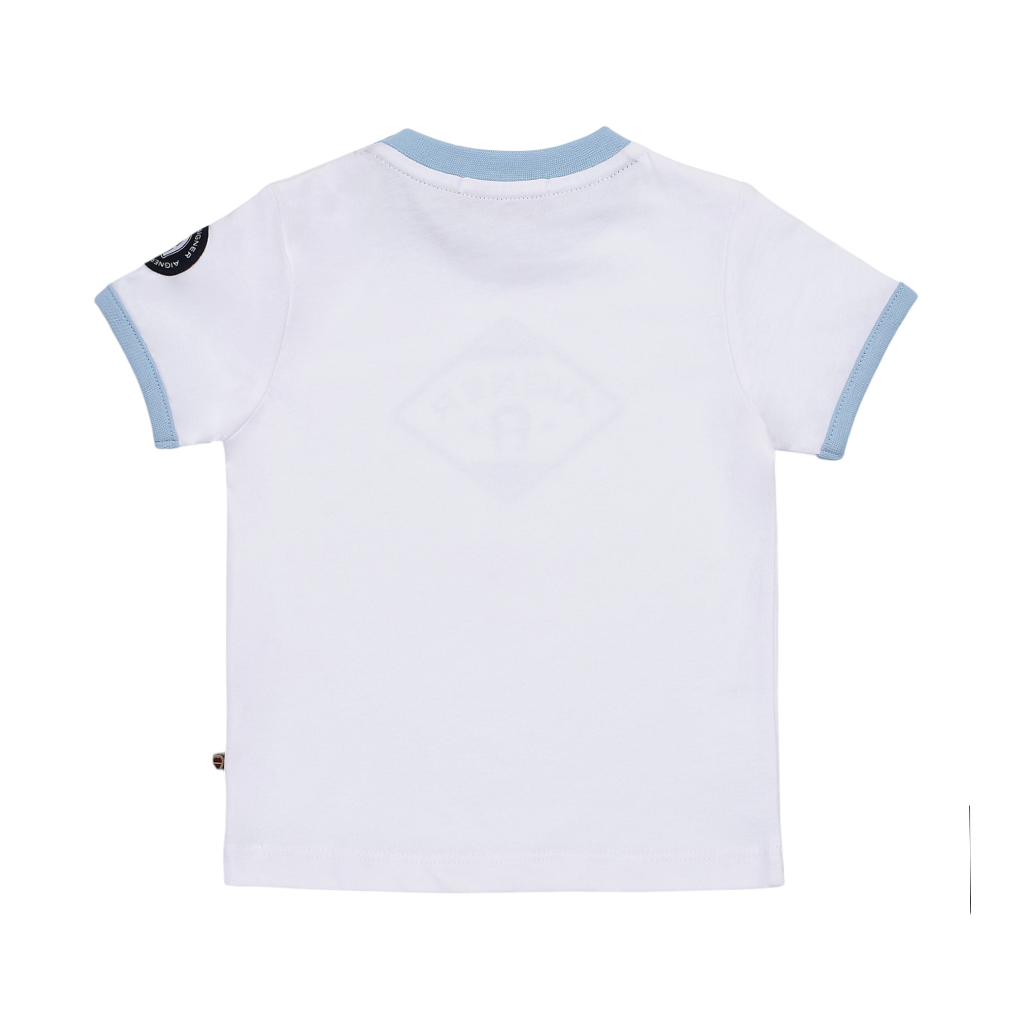 White short-sleeve t-shirt with light blue collar and cuffs. Dark circular patch on left sleeve. Faint diamond graphic on bac