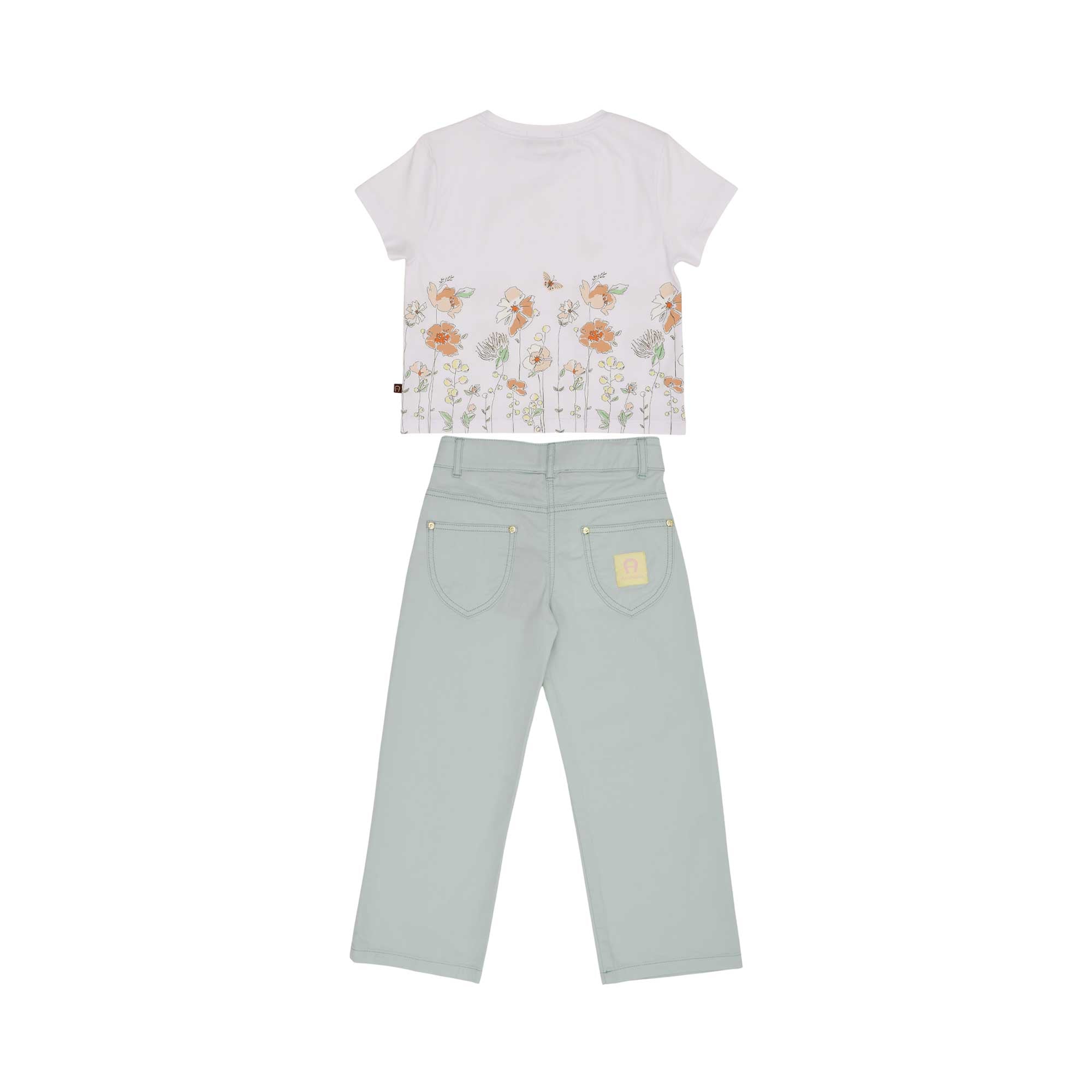 The reverse of the AIGNER Kids set, showing the wraparound floral print on the white t-shirt and the signature yellow logo patch on the sage green trousers.