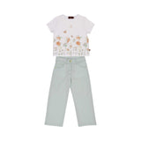 A girls' two-piece outfit featuring a white t-shirt with an orange floral garden and butterfly print, paired with sage green straight-leg trousers.