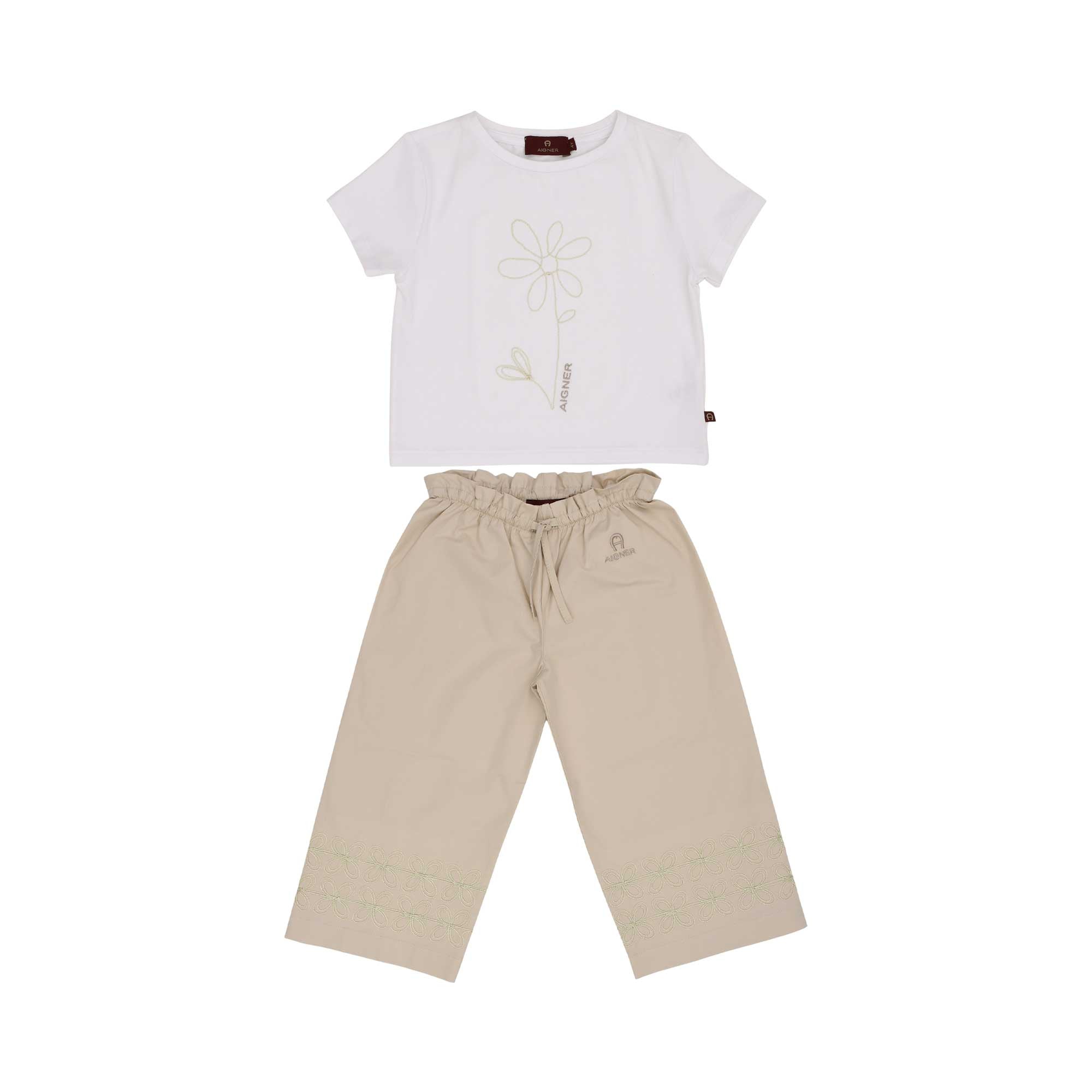 A girls' outfit featuring a white t-shirt with a sage green floral graphic and a pair of beige wide-leg trousers with embroidered floral details at the bottom.