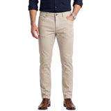 Light beige slim-fit men's trousers with a subtle textured pattern, five pockets, belt loops, and a front button closure.
