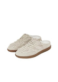 A three-quarter view of a pair of ALOHAS cream leather mules, highlighting the textured lace overlays, white laces, and perforated toe box.