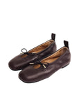 A pair of brown leather ALOHAS Rosalind flats from a three-quarter angle, highlighting the pointed toe and buckle details against a neutral background.