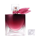 Lancome La Vie est Belle Elixir EDP bottle with a dark cherry red to clear gradient, glittery pink band, and pink fabric bow.