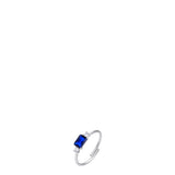 Silver-toned adjustable steel ring with a central blue rectangular zircon and two clear round zircons.