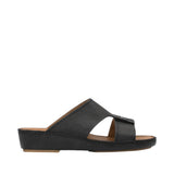Profile view of an Antonio black grained leather Arabic sandal, showing its broad cross-strap upper design and matching leather-wrapped platform wedge sole against a white background.