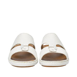 Front-facing view of a pair of Antonio white leather sandals, highlighting the grained texture, central tab with a gold-finish metal bar accent, and open-toe design against a white background.