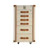 Front view of an Artisan olive green trunk-style jewelry armoire featuring gold hardware, six drawers with handles, and a lockable top.