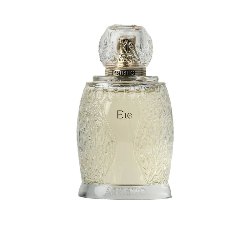 Artist’O Été Eau de Parfum in a clear ornate glass bottle with golden accents, showcasing a fresh summer-inspired fragrance design – Shop the Latest Online