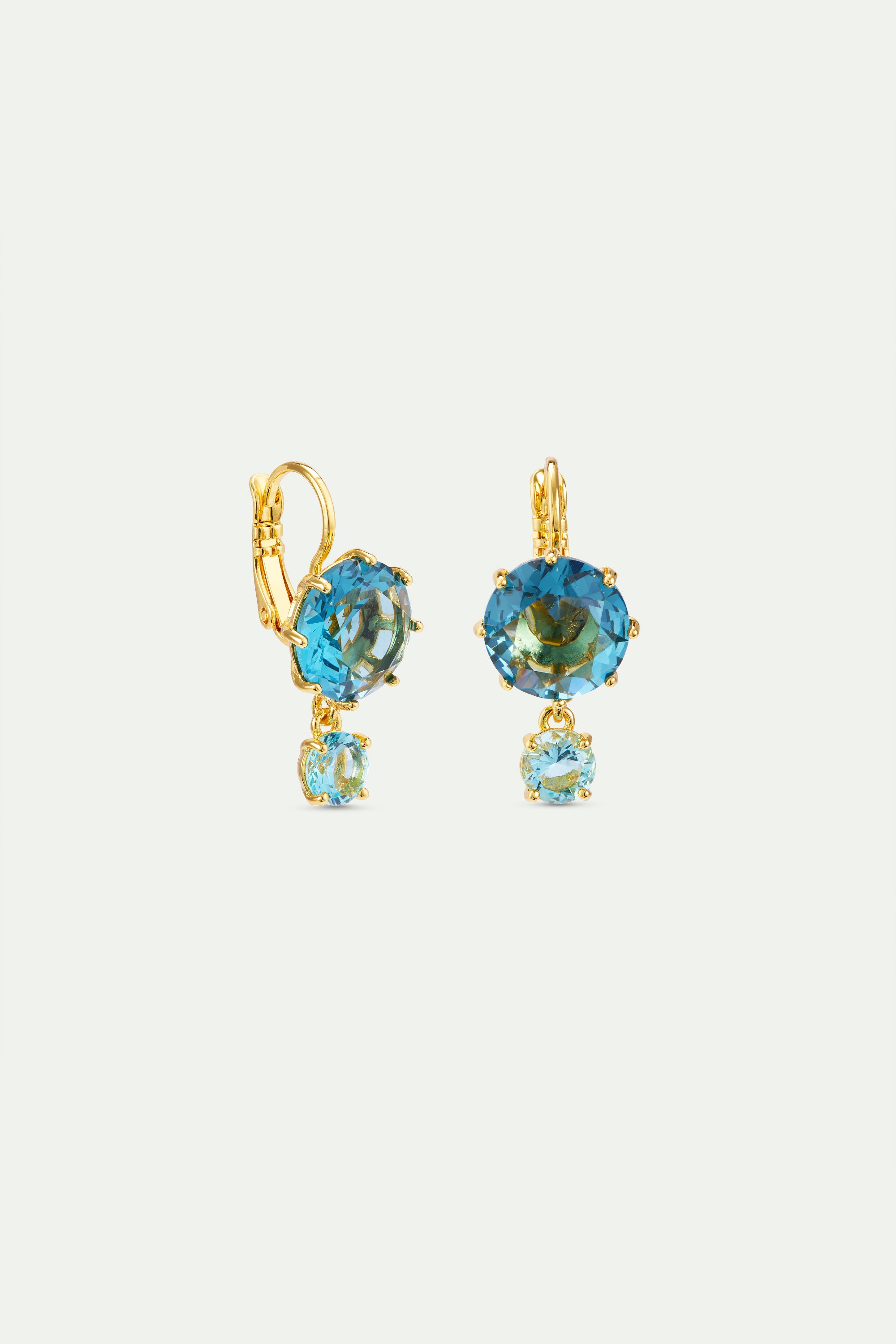 Pair of gold-toned lever-back drop earrings, each with a large round blue-green faceted stone and a smaller oval light blue f