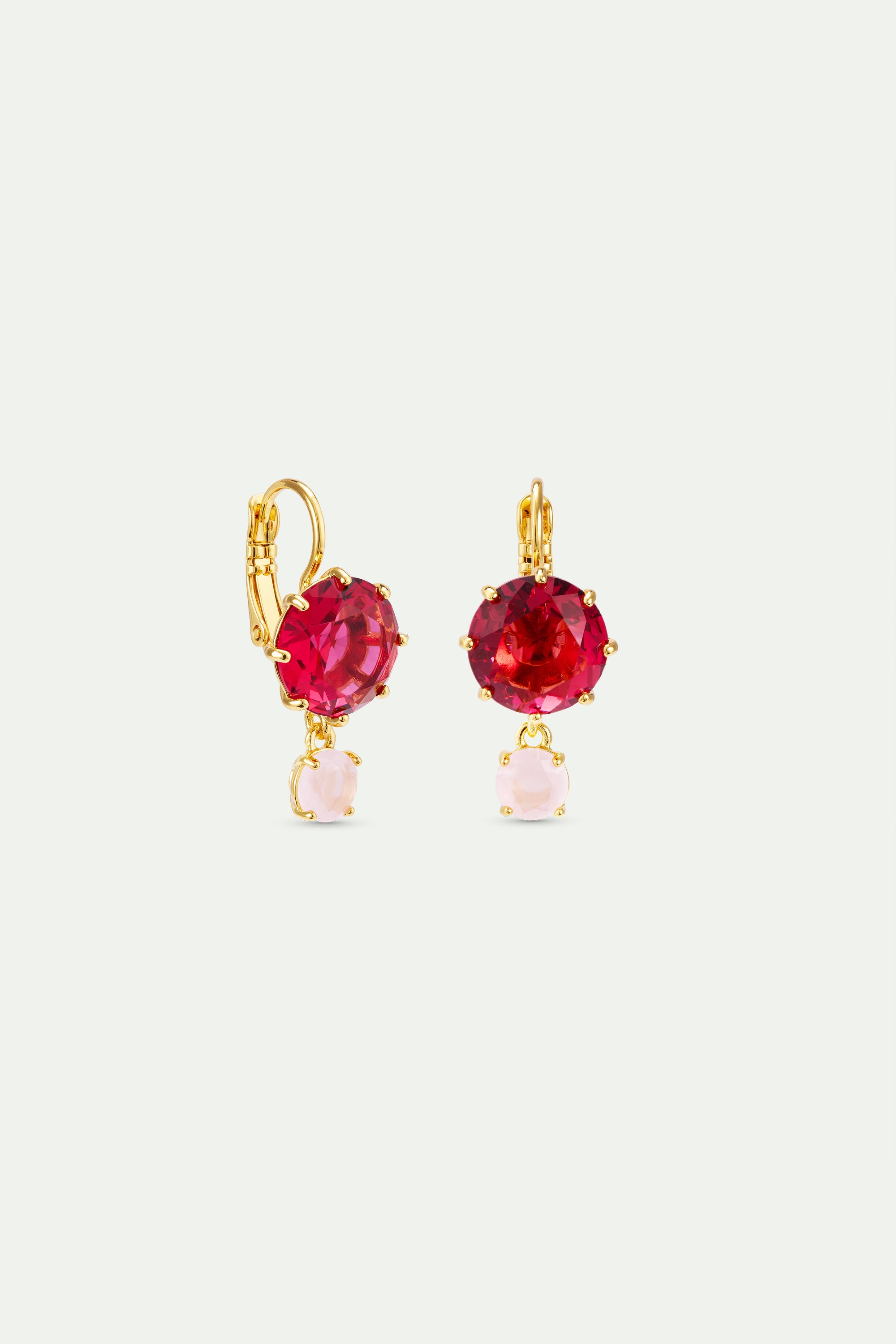 Pair of gold-toned sleeper earrings, each with a large faceted fuchsia stone and a dangling smaller light pink stone.