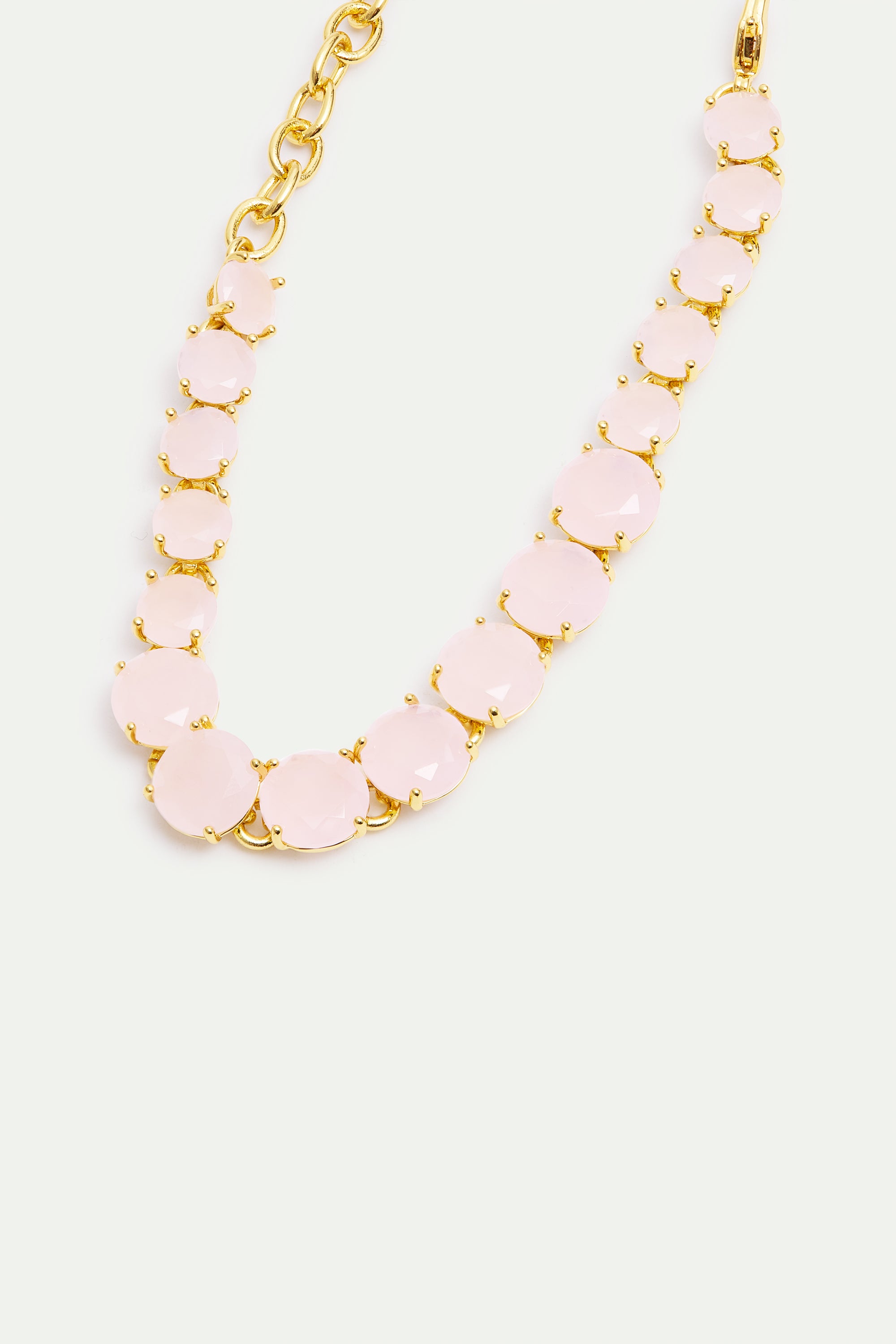 Pale pink faceted round stones in gold-toned prong settings form a bracelet, with a gold-toned chain and clasp.