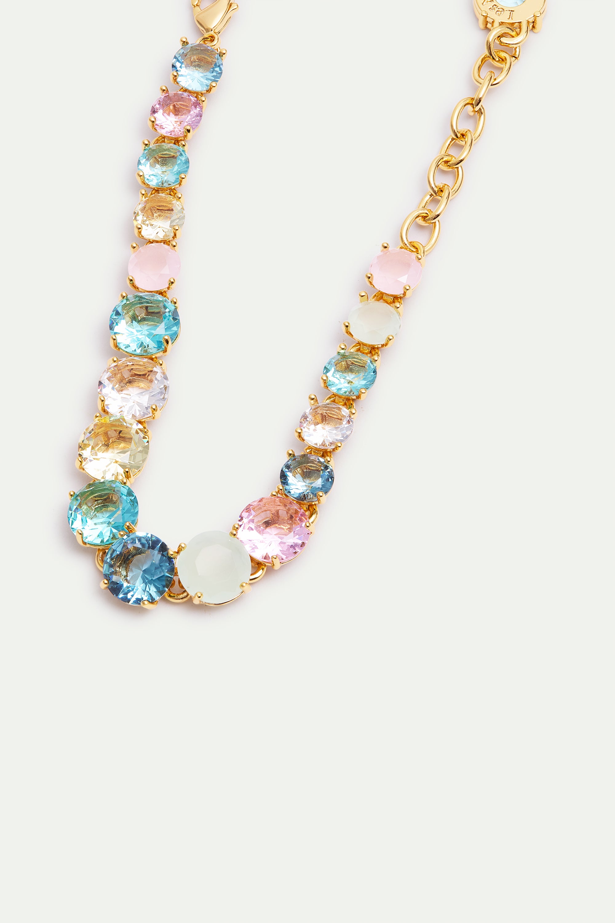 Gold-toned bracelet featuring round, faceted gemstones in pink, light blue, clear, dark blue, and pale green, with a lobster