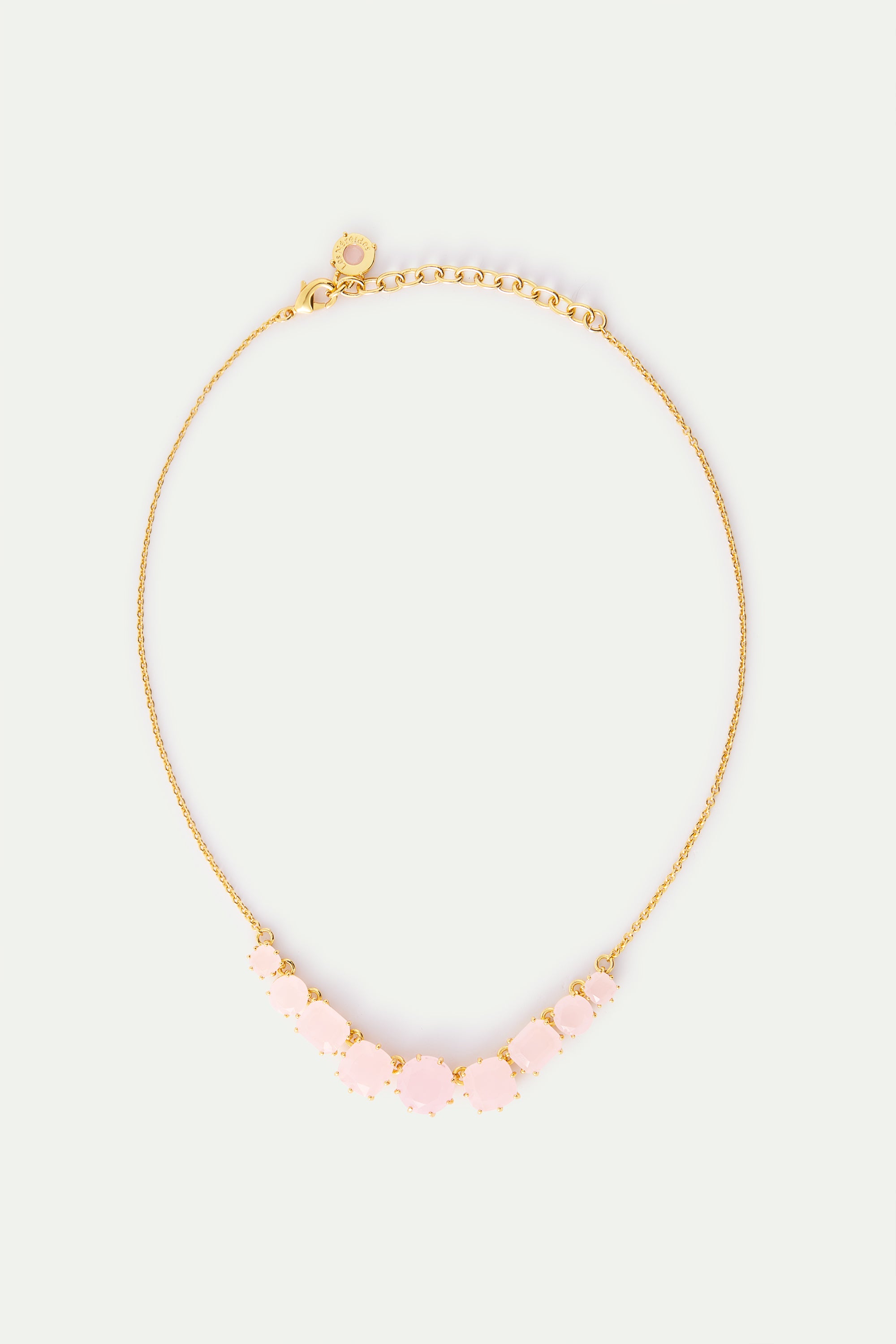 Delicate gold-toned necklace with a graduated arc of 11 faceted pale pink stones, largest in the center, on a fine chain with