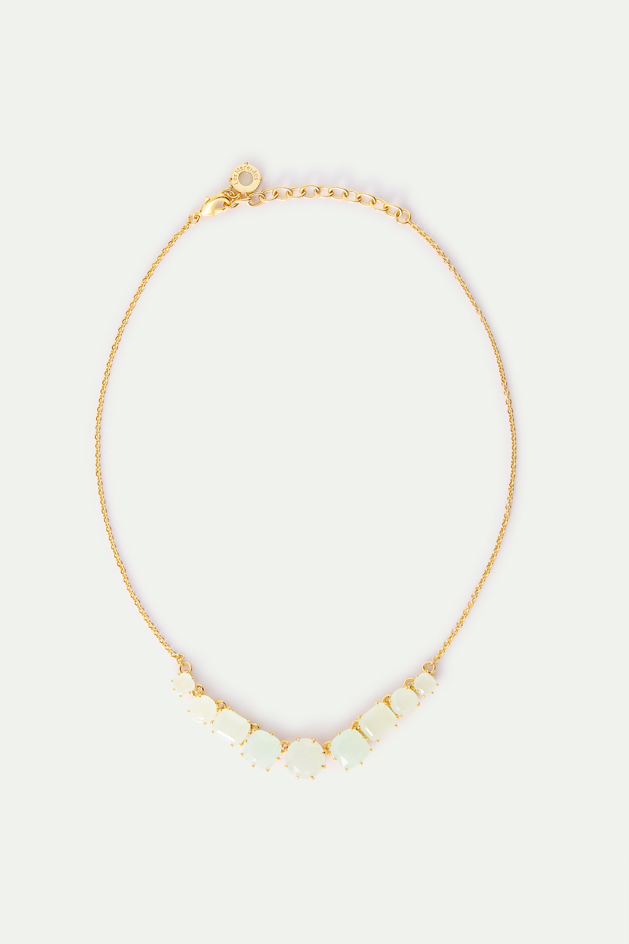 Gold-toned necklace with a delicate chain and a V-shaped arrangement of light green opaque stones in varying rectangular and
