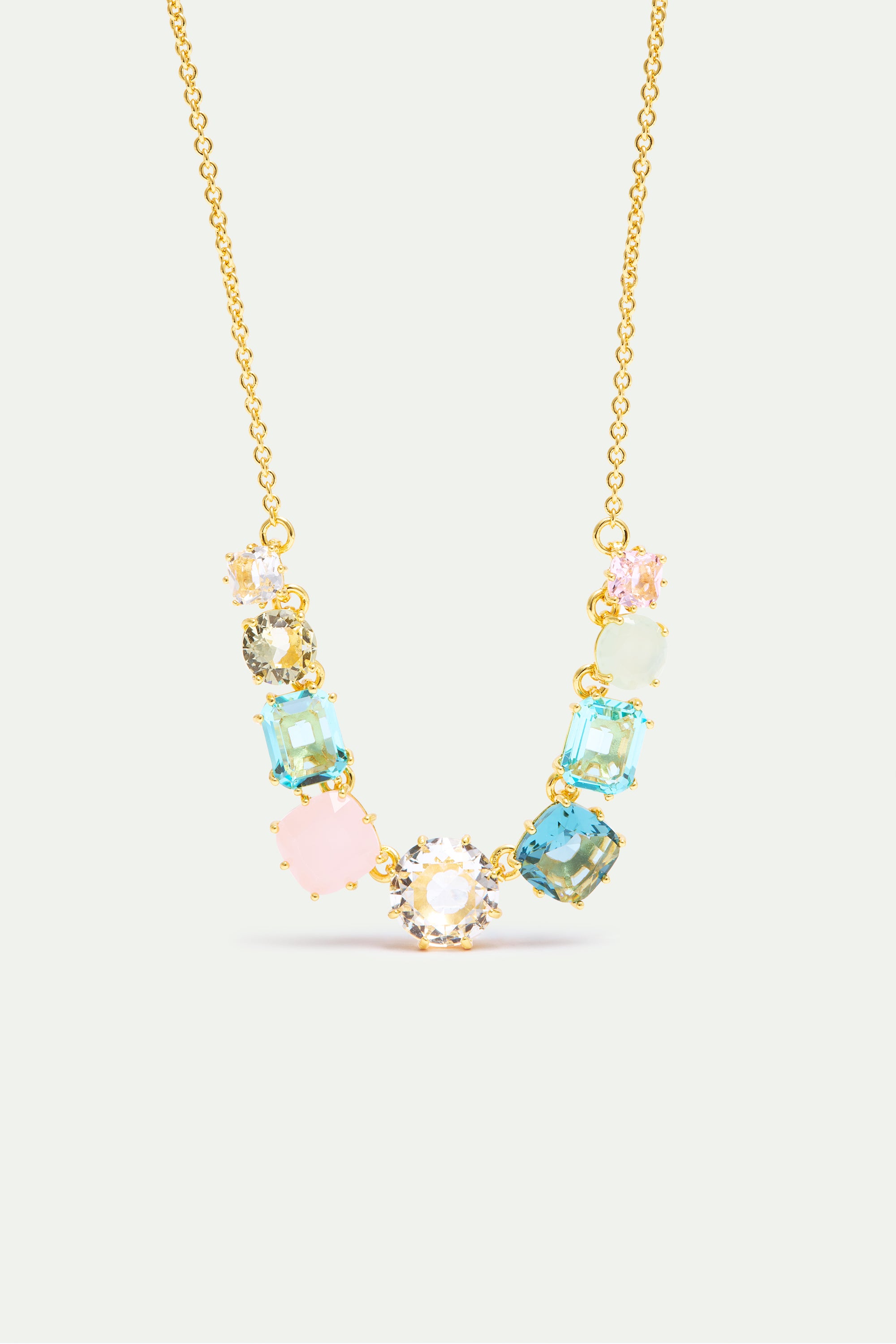 Gold-toned necklace with clear, pink, blue, green, and peach faceted stones in round and cushion cuts.