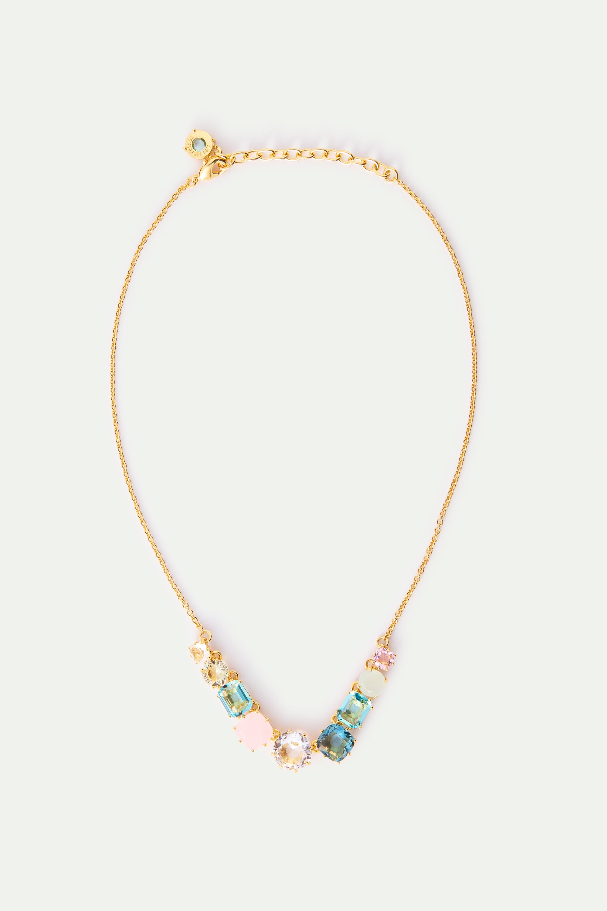 Gold-toned necklace with a V-shaped arrangement of various faceted stones in shades of pink, blue, yellow, and clear.