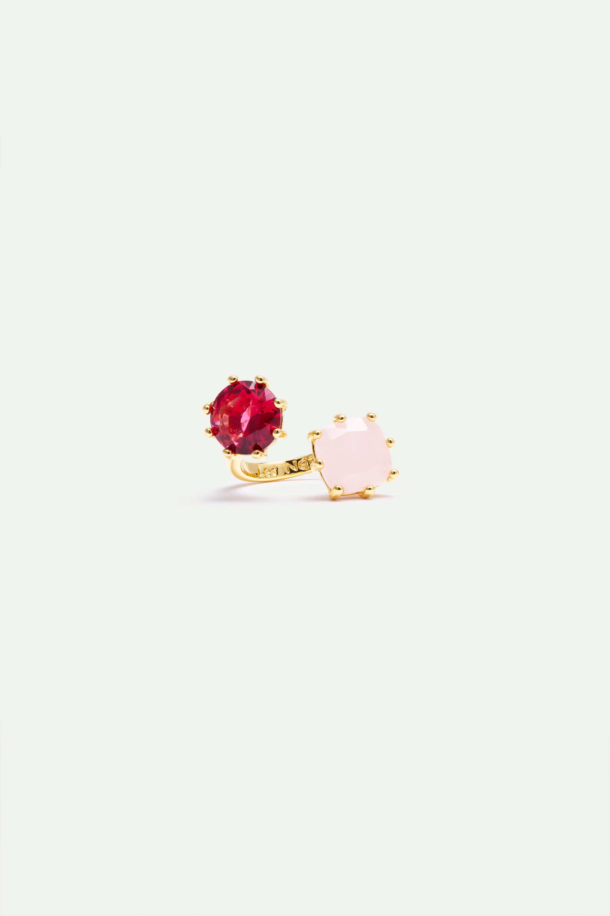 Gold-toned adjustable ring with a round red faceted stone and an octagonal light pink faceted stone, both prong-set.