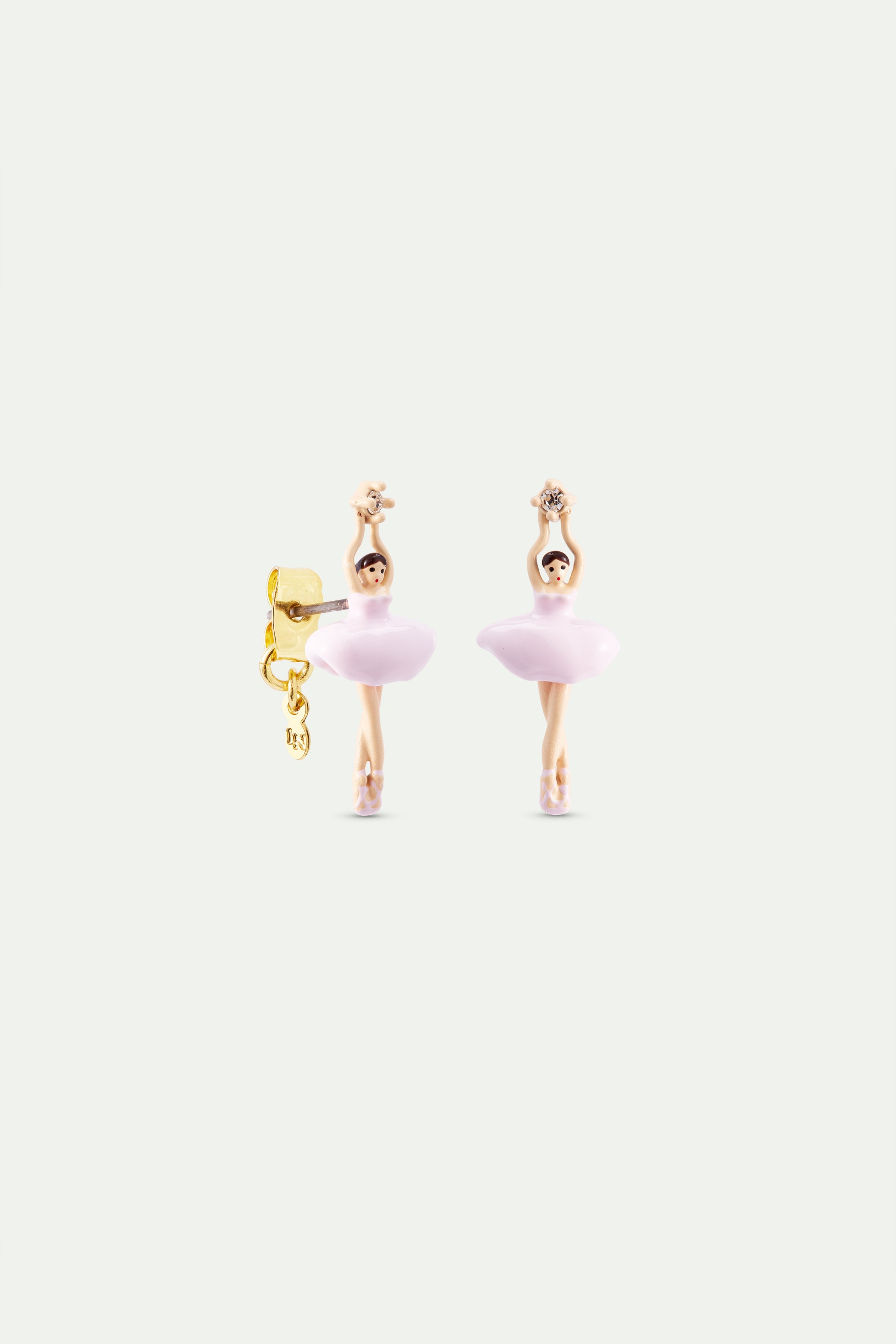 Pair of ballerina earrings. Each features a light-skinned figure in a pink tutu holding a star. The left earring has a gold-t