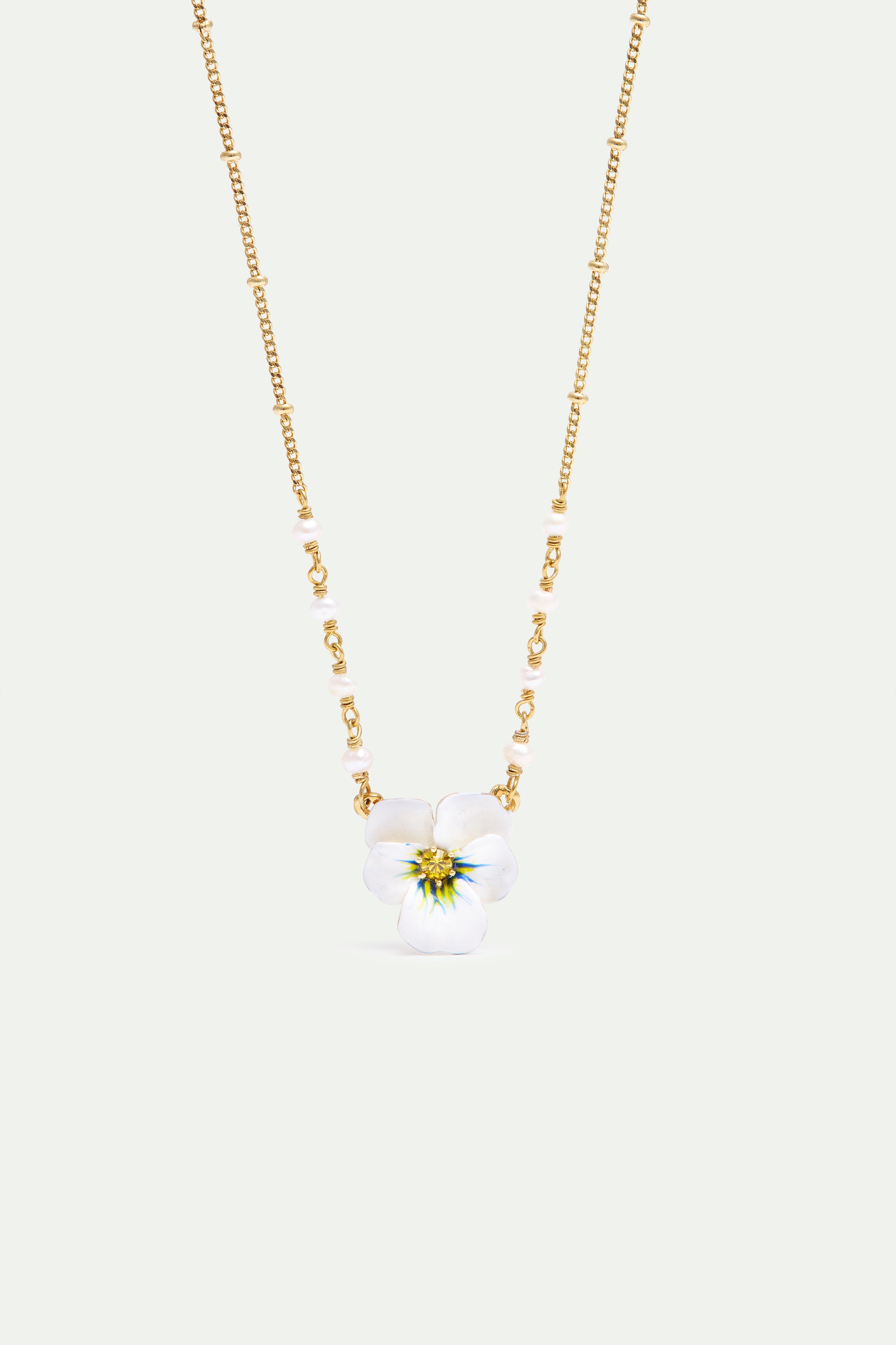 Gold-toned necklace with a white pansy flower pendant featuring blue and yellow accents, interspersed with white pearl-like b