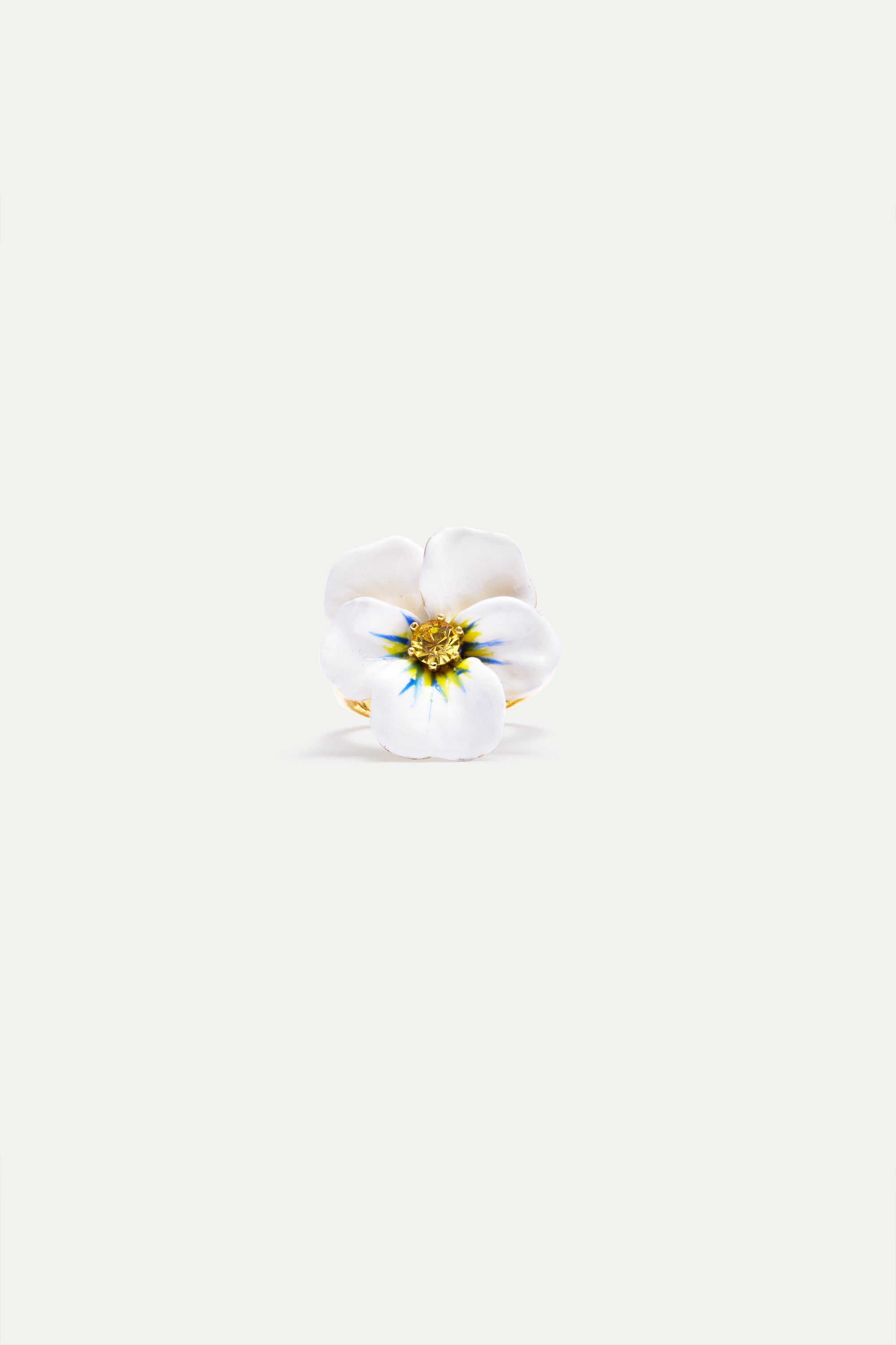 Ring with a white flower design, featuring five petals, a gold-toned center with blue accents, and a gold-toned band.