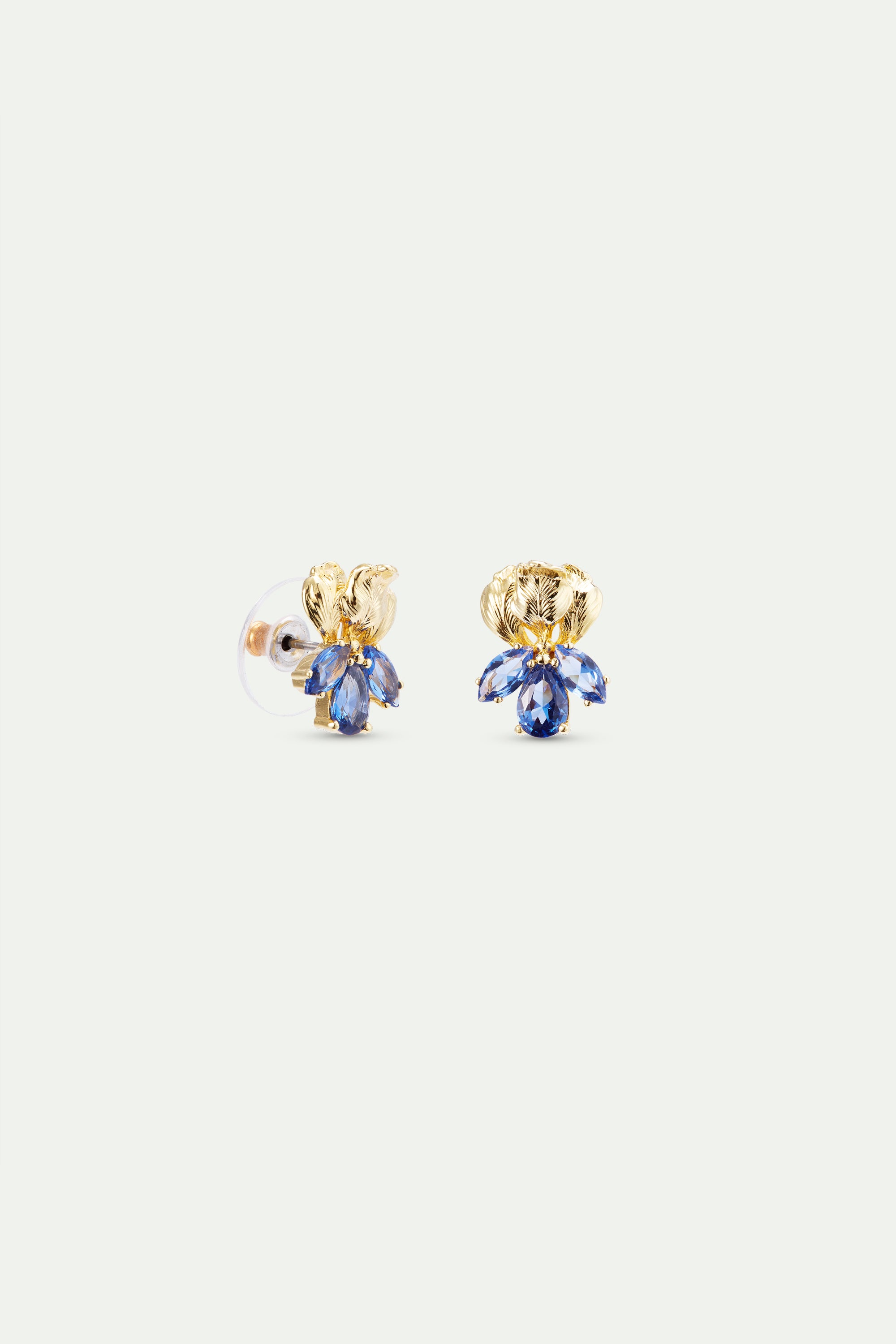 Pair of gold-toned post earrings with textured leaf-like tops and clusters of three blue marquise-cut stones.