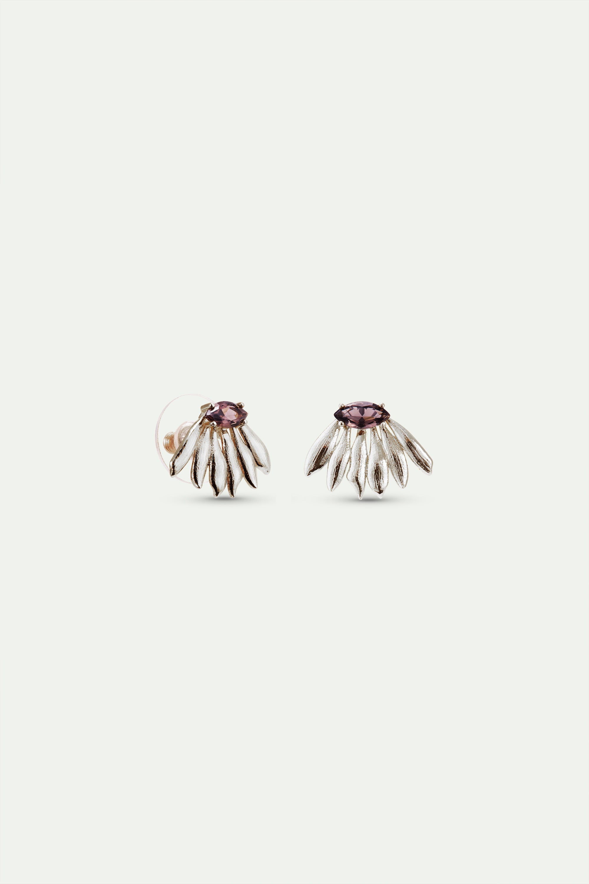 Pair of silver-toned floral stud earrings, each with textured petals and a central oval purple gemstone.