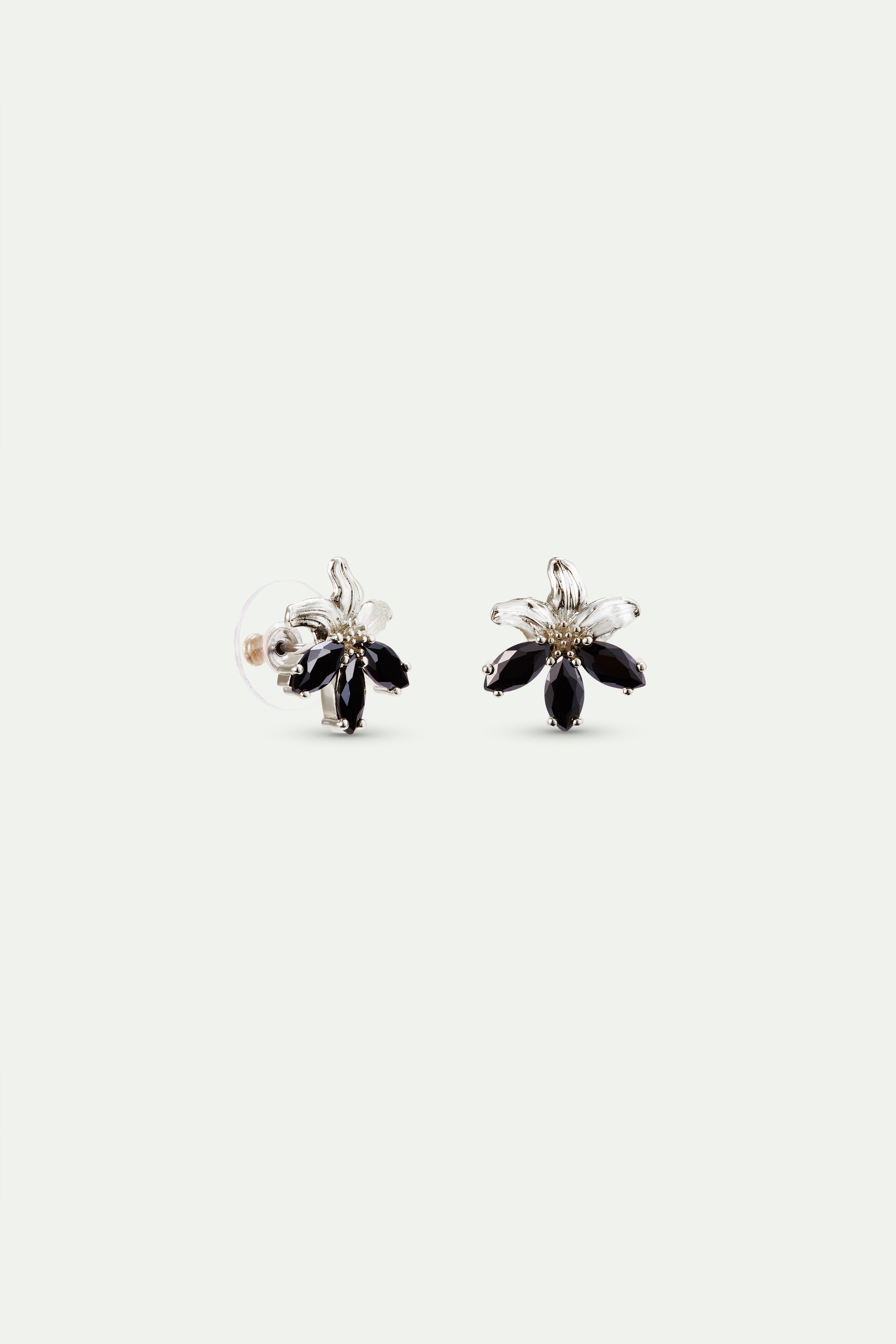 Pair of silver-toned flower post earrings, each with five black marquise-cut stone petals. Left earring shows clear backing.